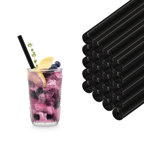 Black 20 cm HALM glass straws stacked beside a berry cocktail with lemon