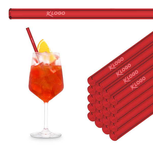 Rote 20 cm HALM Glasstrohhalme mit Beispiel-Logogravur im Stapel neben einem Aperol Spritz im Weinglas