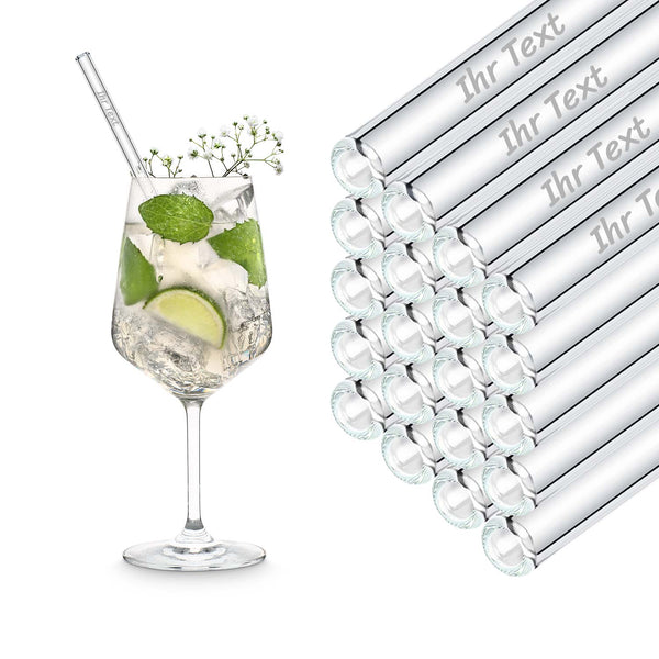 20 cm HALM Glasstrohhalme mit Beispiel-Textgravur im Stapel neben einem Hugo im Weinglas